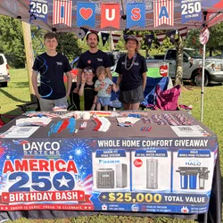 Dayco Employees at Dayco Systems booth in Rome GA with patriotic decor promoting America 250th Birthday Bash and $25,000 value giveaway.