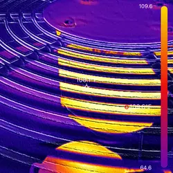 Thermal image showing heat distribution on a circular metal surface with temperature readings.