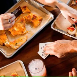 a group of people sitting at a table with food on it