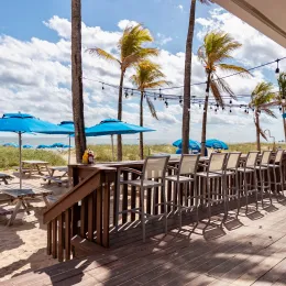 a beach with tables and chairs