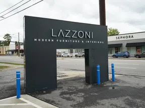 Black Lazzoni modern furniture and interiors sign with a Sephora store and street in the background