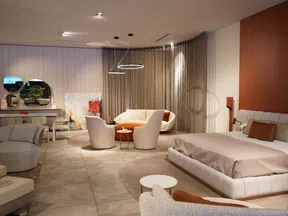 Modern living room and bedroom combination with neutral tones, circular seating area, and minimalist decor.