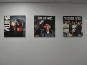 Three wall posters promoting welding skills with images of welders and motivational text.