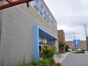 Exterior view of a Ross Dress for Less store with Walmart in the background on a cloudy day