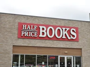 Half Price Books store front with red sign and glass windows showing book sections inside