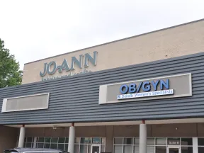 Exterior of a building with JO-ANN Fabrics and Crafts and OB/GYN Dekalb Women’s Specialists signs.