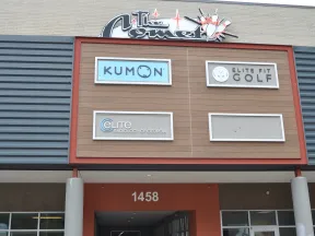 Storefront signs for Kumon, Elite Fit Golf, and Elite Radiology of Georgia on a building facade with address 1458