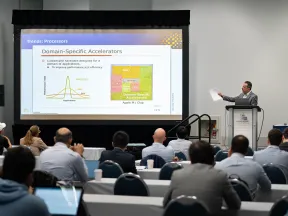 Presenter discussing domain-specific accelerators on a slide to an audience in a conference room.