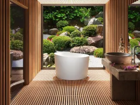 Modern bathroom with freestanding white tub and wood slat walls overlooking lush Japanese rock garden.