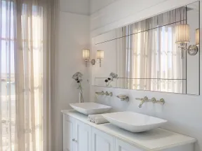 Modern bathroom with dual vessel sinks, large mirror, wall sconces, and sheer curtains letting in natural light