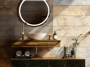 Modern bathroom vanity with round illuminated mirror, vessel sink, wooden shelves, and decorative items.