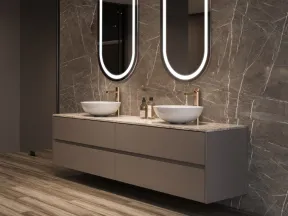 Modern bathroom with floating vanity, dual vessel sinks, oval LED mirrors, and marble wall with wood-look flooring.