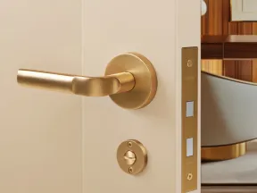 Modern gold door handle and lock on a beige door with a stylish interior background.