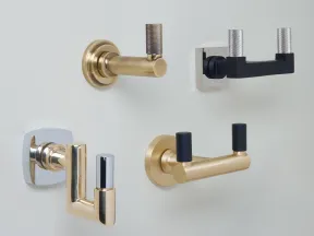 Four modern wall-mounted coat hooks in gold, black, and chrome finishes on a white background.