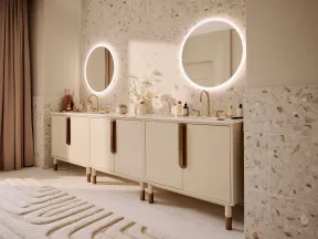 Modern bathroom with double vanity, round LED mirrors, brass faucets, and terrazzo wall tiles in soft beige tones