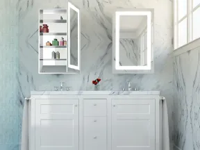 Modern bathroom with white marble walls, double sink vanity, lighted mirrors, and open medicine cabinet with toiletries.