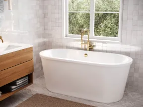Modern bathroom with freestanding white bathtub, brass faucet, wood vanity, and large window with greenery outside