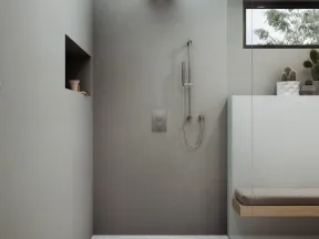 Minimalist modern gray shower with rain showerhead, handheld shower, built-in shelf, glass partition, and window with plants.
