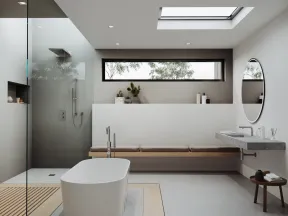 Modern minimalist bathroom with freestanding tub, glass shower, skylight, and wooden bench seating.