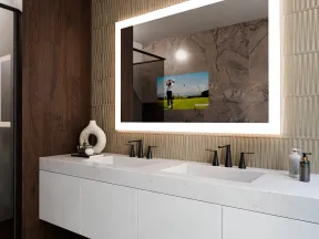 Modern bathroom with double sink, illuminated rectangular mirror, textured beige wall, and dark wood accent.
