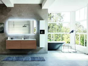 Modern bathroom with floating wooden vanity, illuminated mirror, gray bathtub, large windows, and concrete floor.