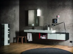 Modern bathroom with floating vanity, large mirror, wooden stool, and minimalist decor on textured gray wall.