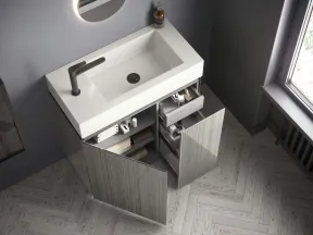 Modern bathroom vanity with white rectangular sink, matte faucet, open cabinets, and wooden herringbone floor