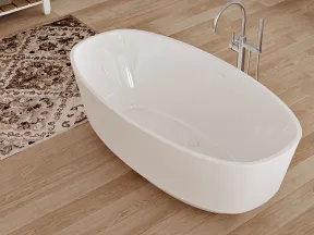 Modern white freestanding bathtub on light wooden floor with decorative rug and chrome faucet.