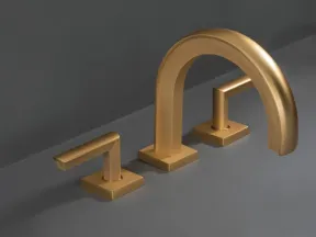 Modern matte gold bathroom faucet set with minimalist design on gray surface and background.
