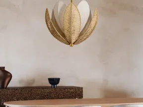 Elegant dining room with beige chairs, wooden table, unique leaf-shaped pendant light, and textured sideboard.