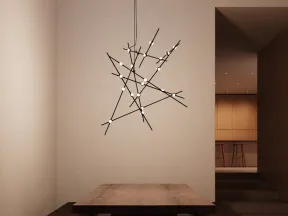 Modern dining area with wooden table, benches, and black geometric chandelier with small round lights