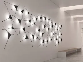 Modern hallway with illuminated abstract geometric wall art and a minimalist bench on light wood flooring.