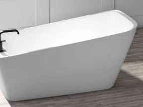 Modern white freestanding bathtub with black faucet on wood-look floor in minimalistic bathroom
