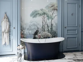 Elegant bathroom with navy freestanding tub, detailed wall mural of trees, blue paneled walls, and modern chandelier