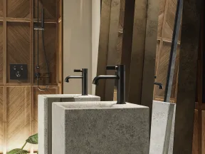 Modern bathroom with concrete sink, matte black faucet, large mirror, and wood tile shower wall.