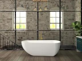 Modern bathroom with freestanding white bathtub, stone walls, wooden floor, and dark green vanity under golden lighting.