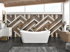 Modern bathroom with freestanding white tub, geometric wood accent wall, large plant, and natural light.