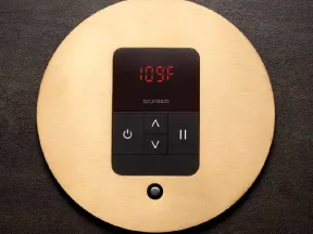 Temperature control panel displaying 109°F on a circular gold plate with black buttons and LED screen.