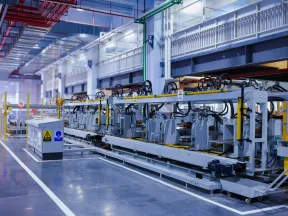 Modern manufacturing plant interior with automated machinery and industrial equipment on polished floor.