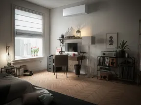 Modern bedroom with a desk, computer, and window letting in natural light over wooden herringbone floors.