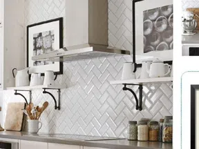 White kitchen with herringbone tile backsplash, stainless steel hood, open shelves with white ceramics, and glass jars.