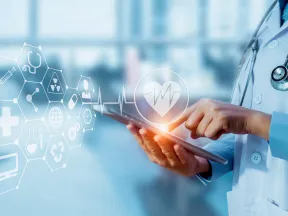 Doctor holding tablet with medical icons and heart rate graphic in a modern healthcare setting.