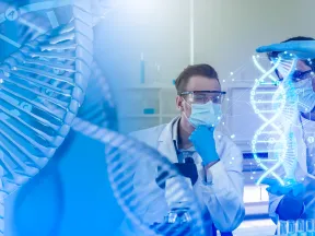 Scientists in lab coats and masks study a glowing digital DNA model with blue scientific background.