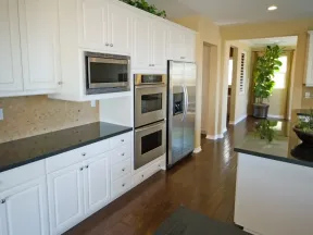 a kitchen with white cabinets