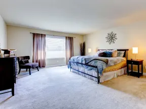 a bedroom with a bed and a chair
