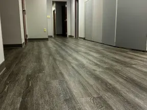 a hallway with doors and a wood floor