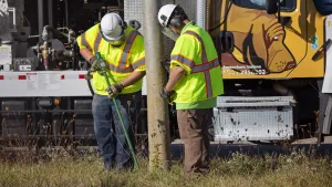 Two men from Blood Hound performing sub-surface utility engineering with truck