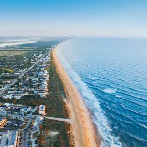 a beach with buildings and water