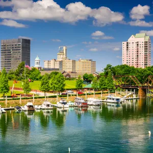 a body of water with boats in it and buildings in the back