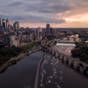a river with a bridge and a city in the background